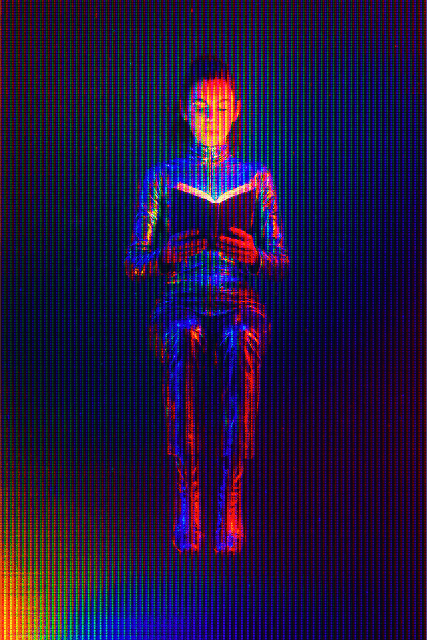 A futuristic woman reading a book.